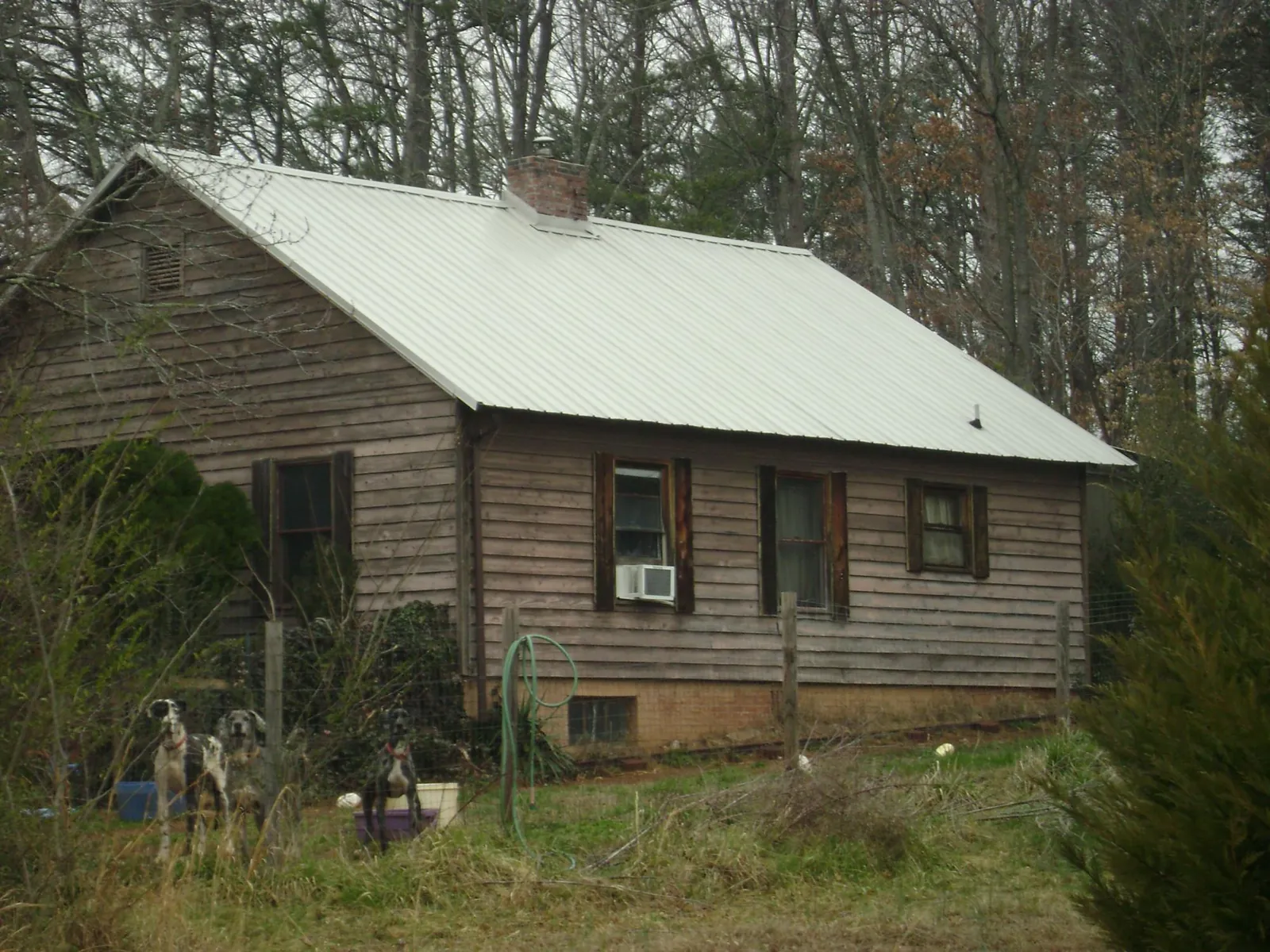White metal roof on an old wood sided farmhouse, from a Metal Roof Installation job in Hammondsport